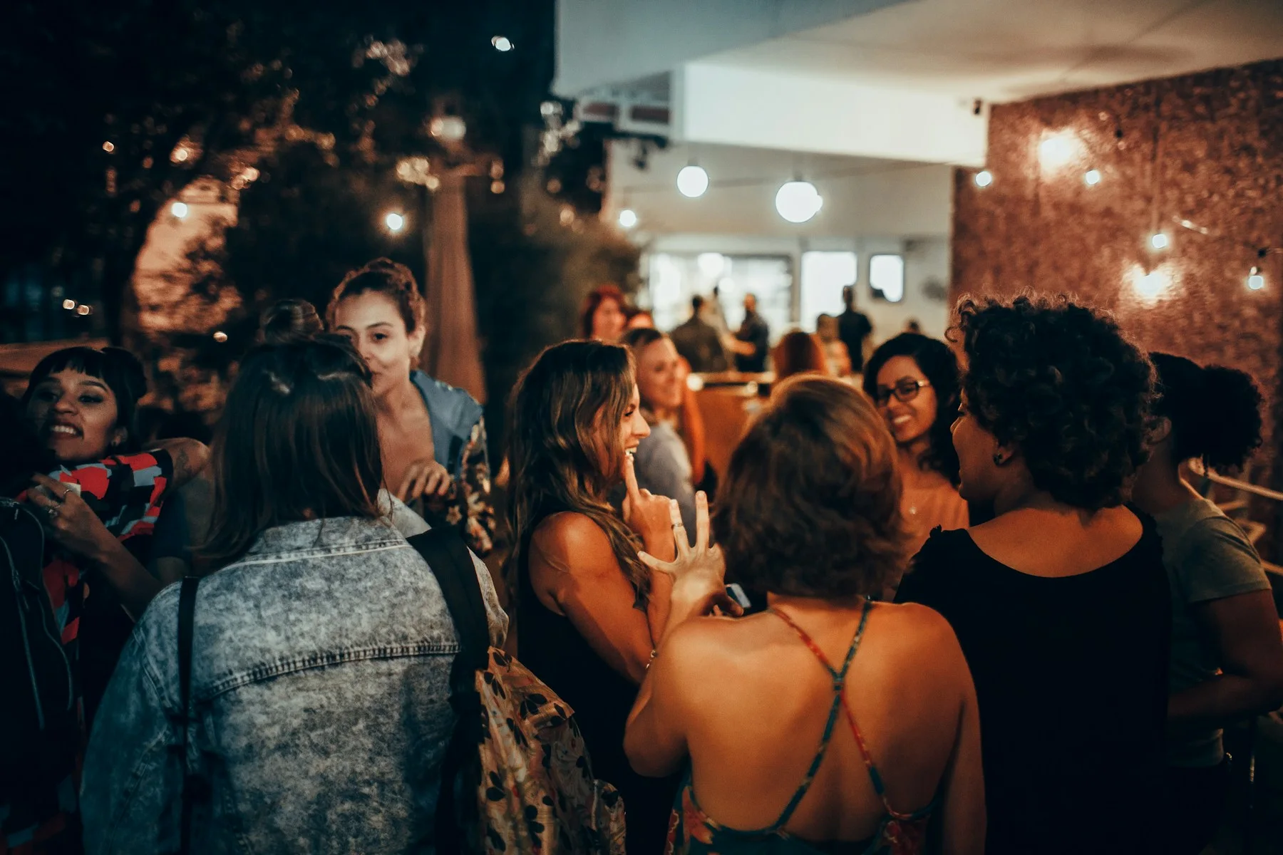 People gathered around a table at an evening get-together